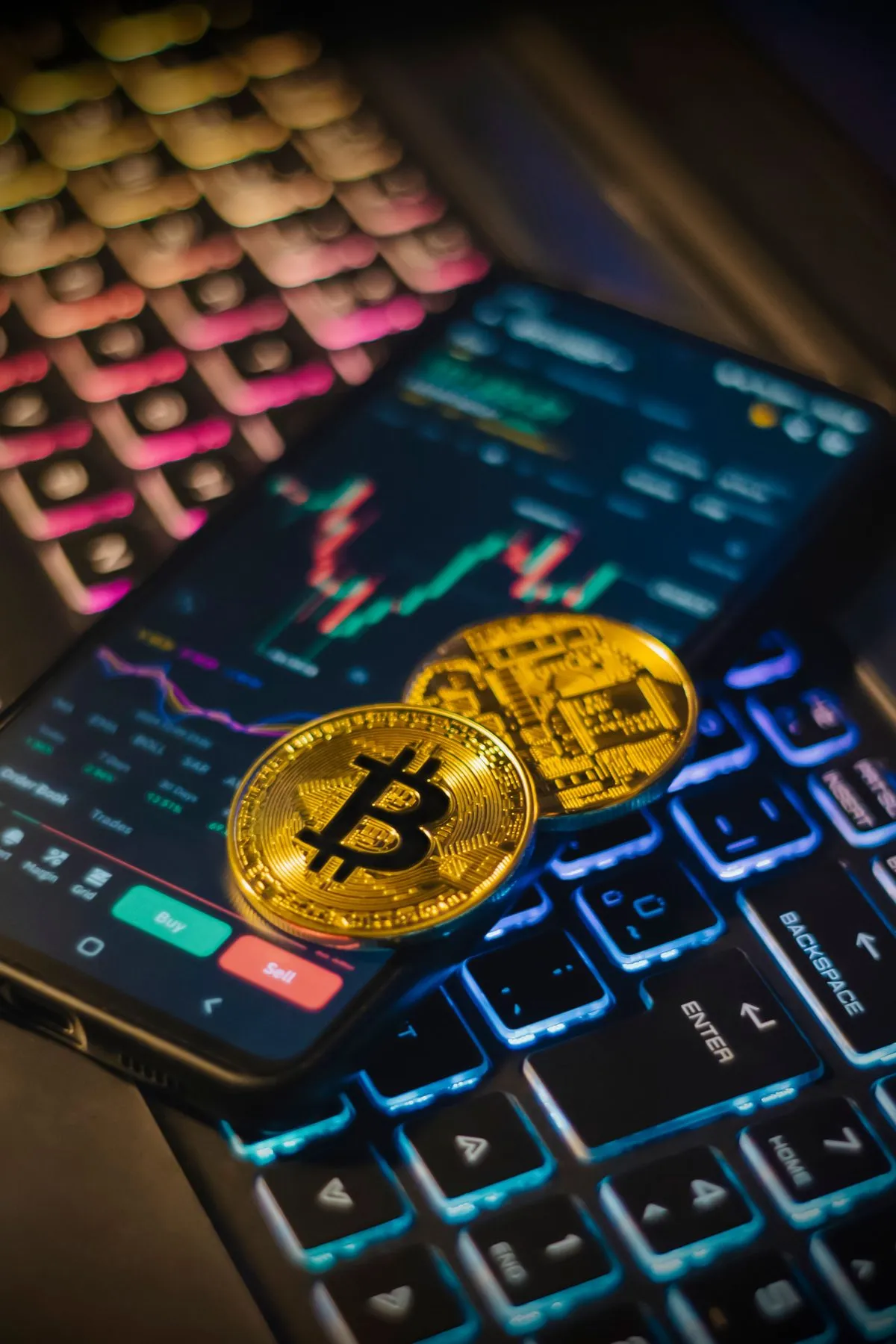 Crypto coins on a keyboard, illustrating buying Litecoin online and at ATMs in Georgia