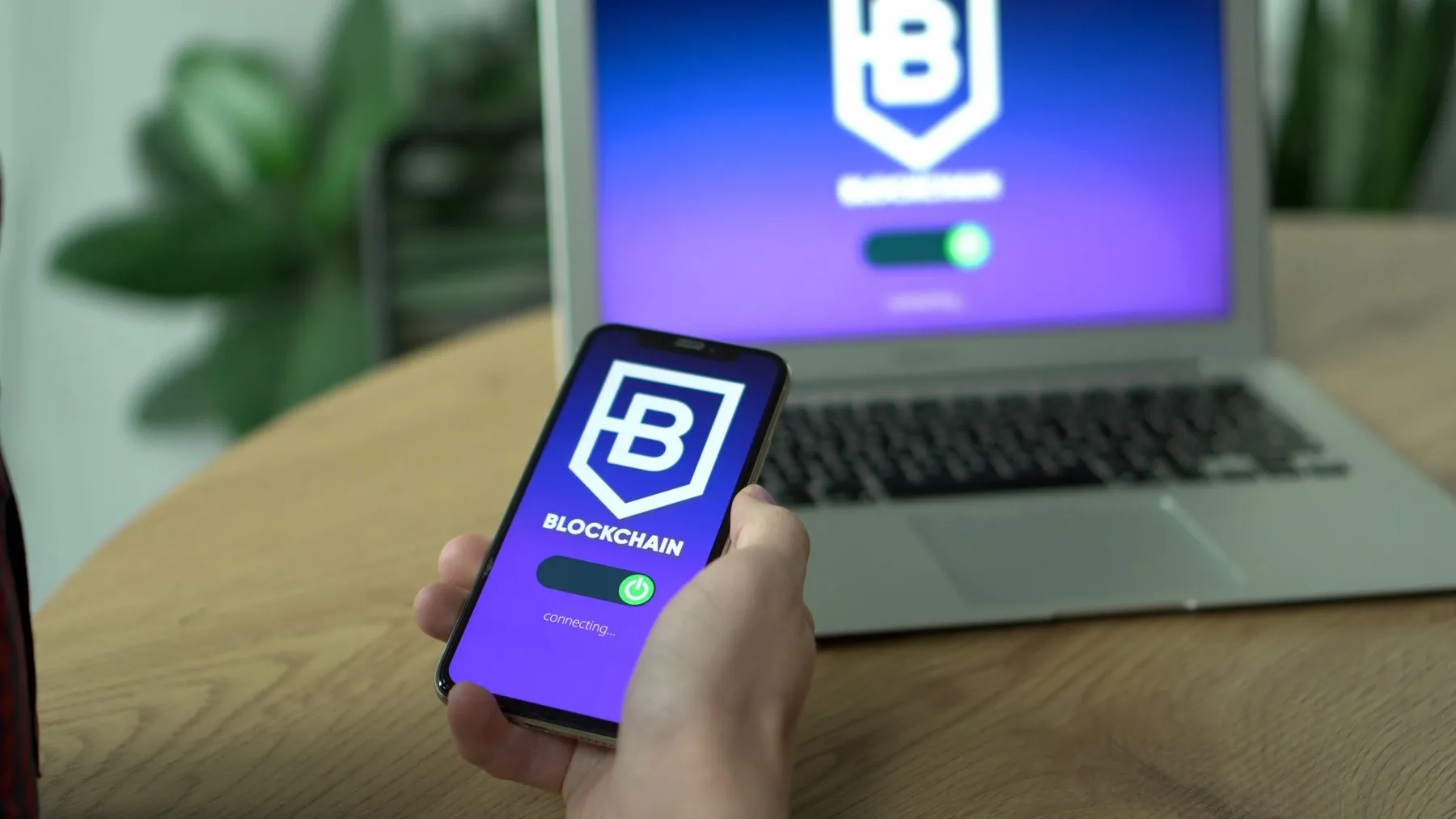 Blockchain wallet app open on a phone next to a laptop