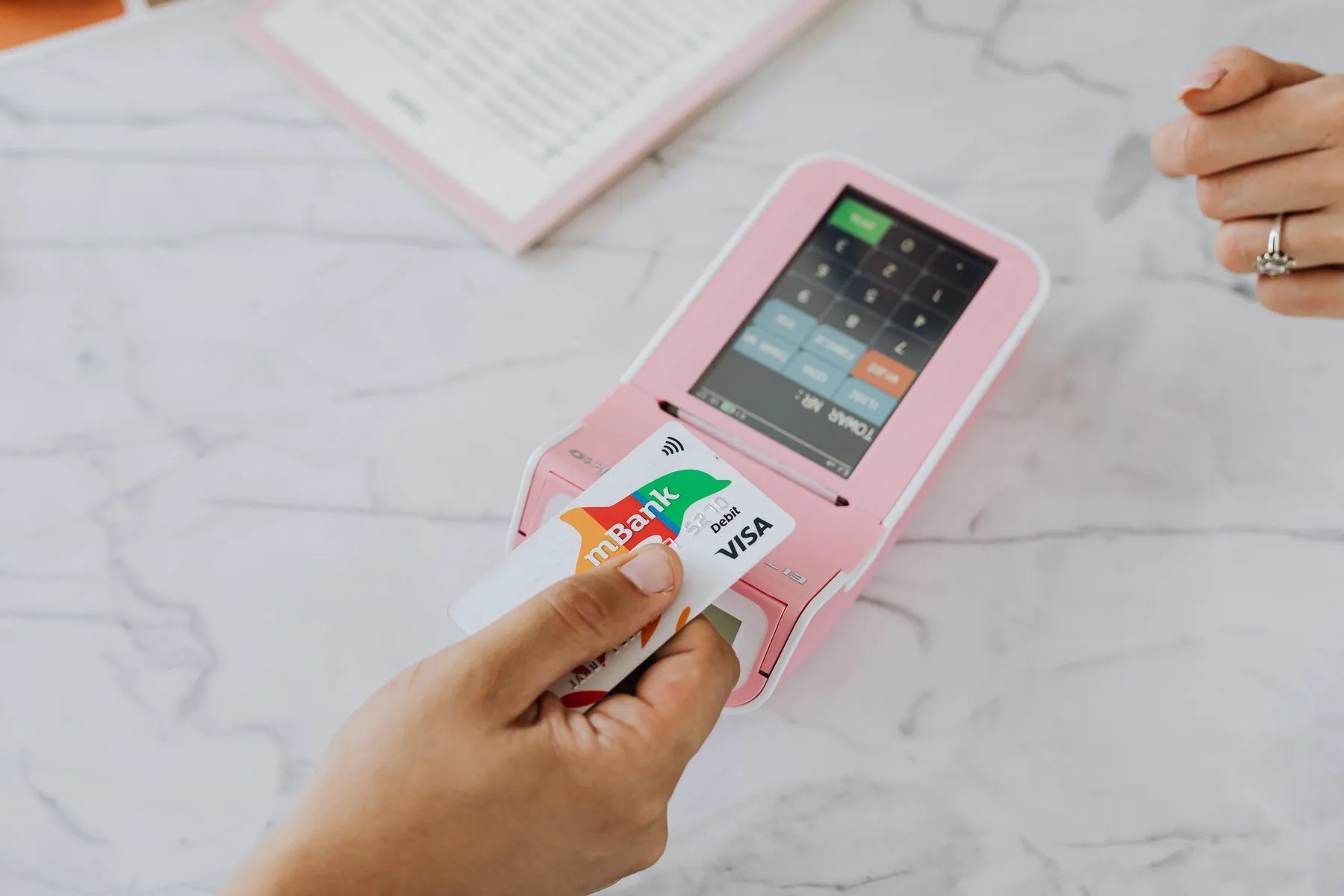 Contactless card payment at a terminal, illustrating buying crypto with lari in Rustavi