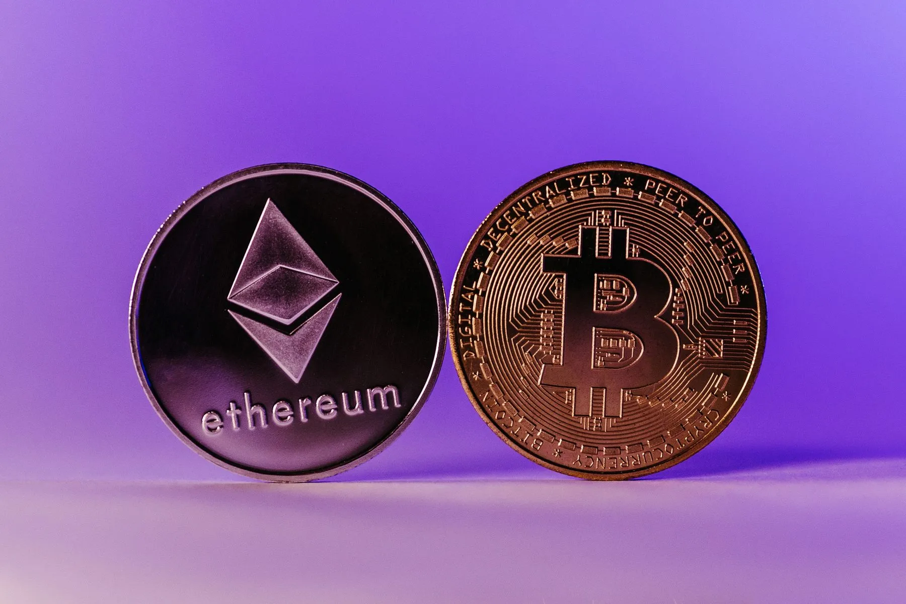 Ethereum and Bitcoin coins lying side by side