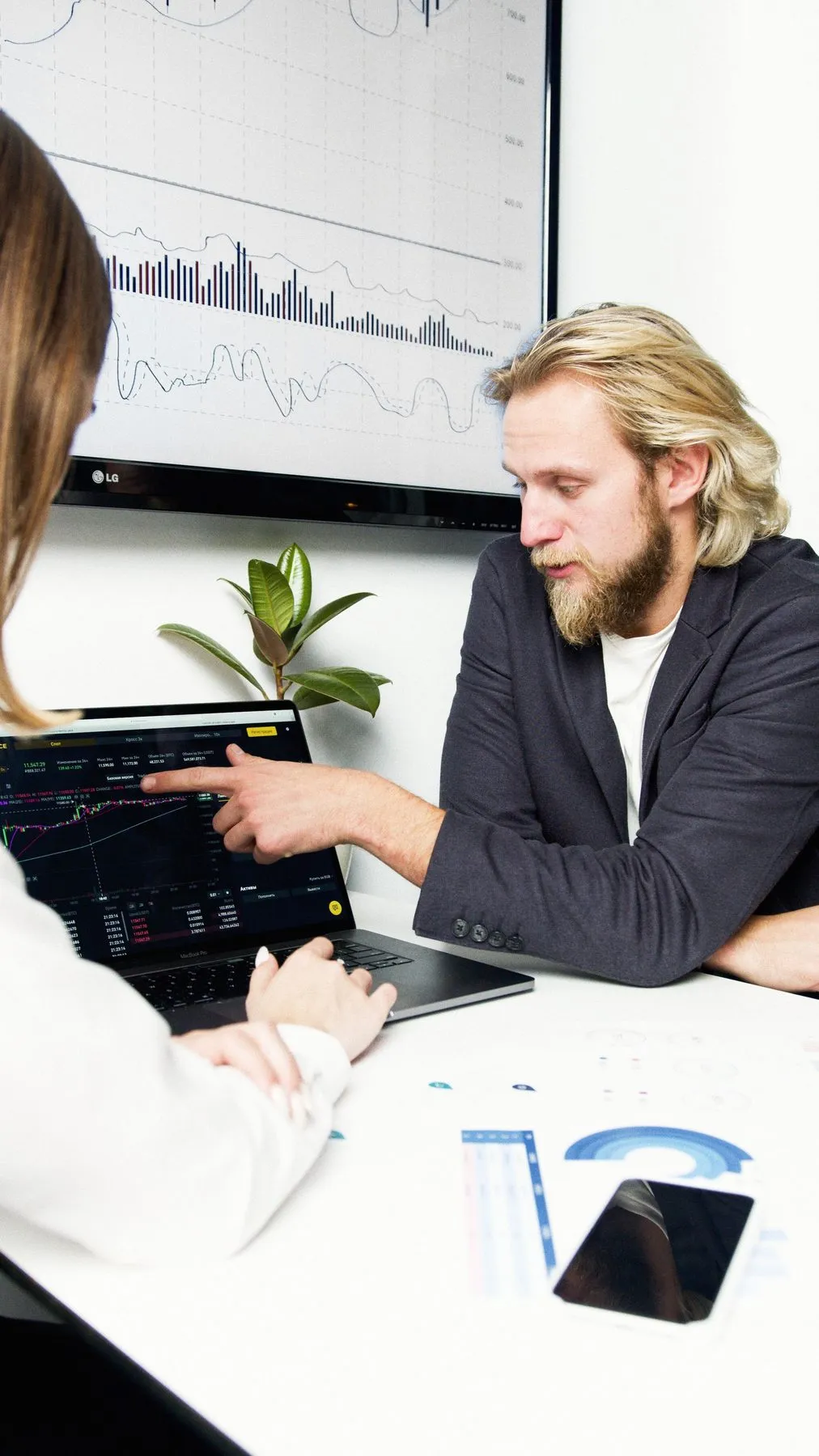 Client and consultant at a desk in a small financial services office
