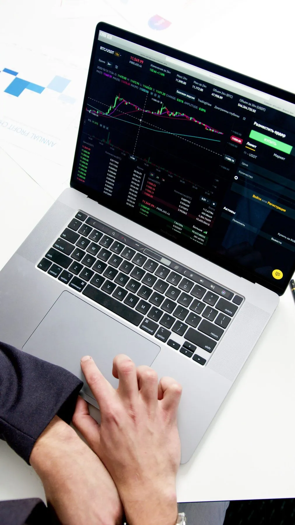 Laptop with a crypto trading dashboard and price charts