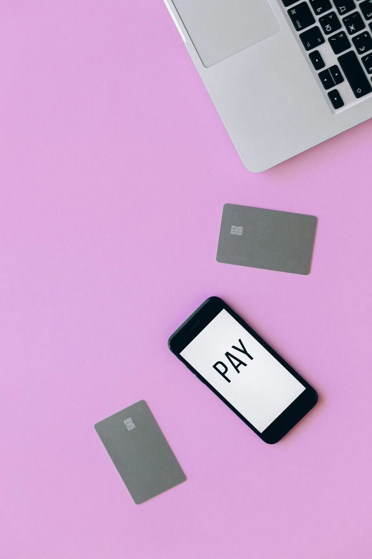 Smartphone and payment cards laid out on a table, representing the crypto and banking apps used in Georgia