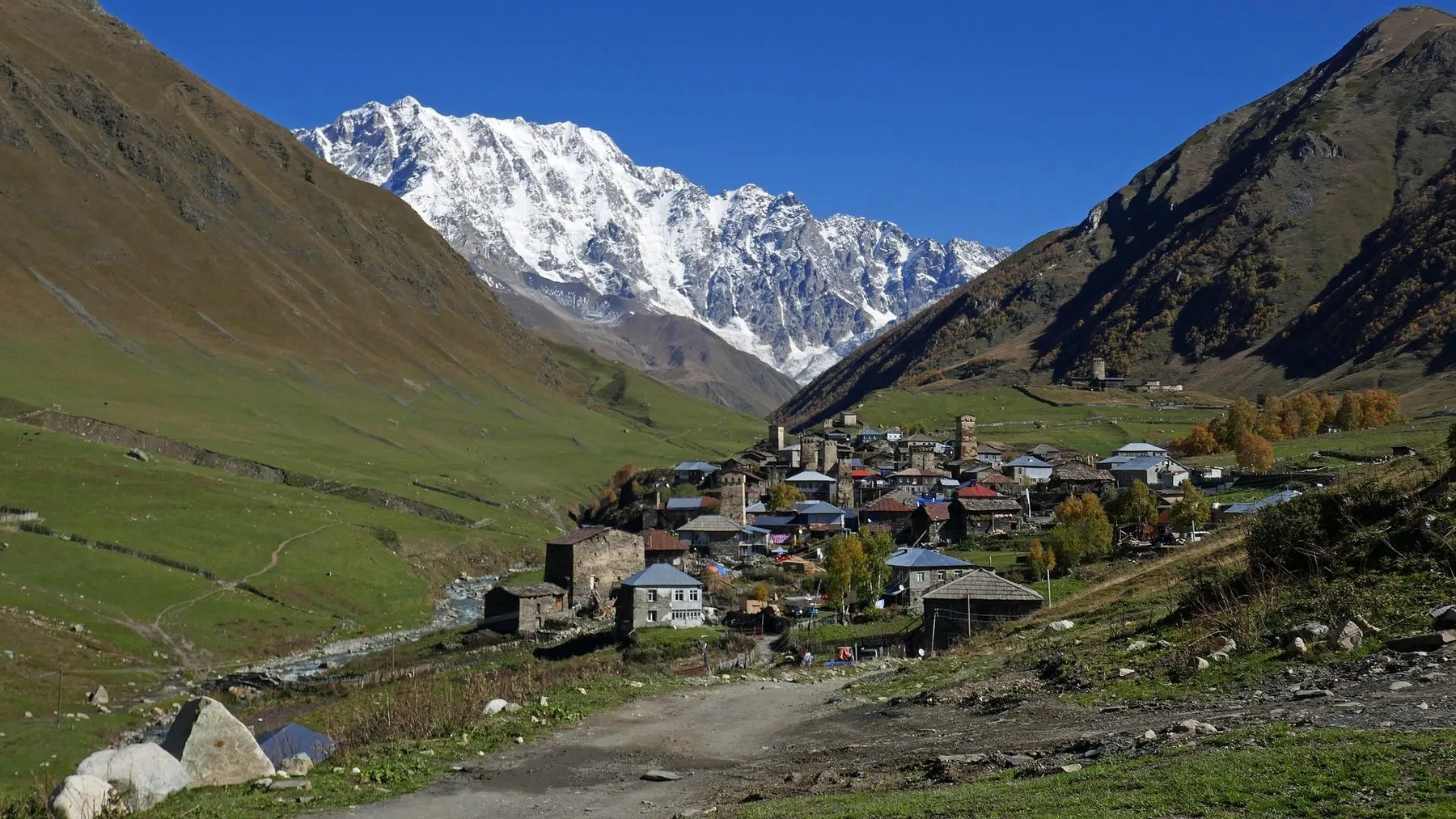 Medieval towers of Ushguli in Svaneti below snow-capped Caucasus peaks, the region at the centre of Georgia's mining power dispute